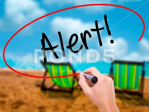 Man Hand writing Alert! with black marker on visual screen Stock Photos