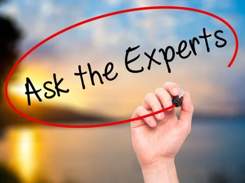 Man Hand writing Ask the Experts with black marker on visual scr Stock Photos
