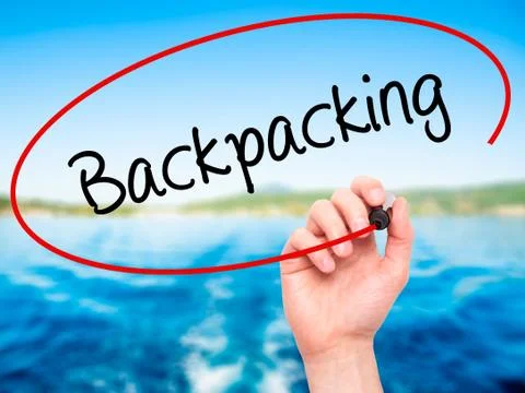 Man Hand writing Backpacking  with black marker on visual screen Stock Photos