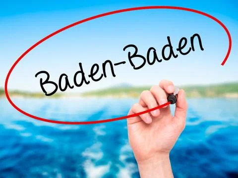 Man Hand writing Baden-Baden with black marker on visual screen. Stock Photos