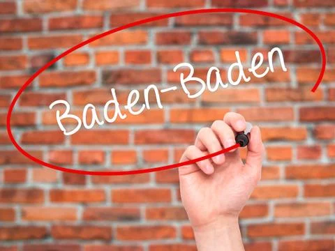 Man Hand writing Baden-Baden with black marker on visual screen. Stock Photos