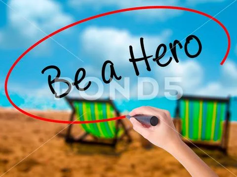 Man Hand writing Be a Hero with black marker on visual screen Stock Photos