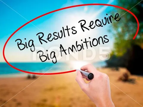 Man Hand writing Big Results Require Big Ambitions with black ma Stock Photos