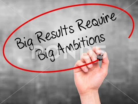 Man Hand writing Big Results Require Big Ambitions with black ma Stock Photos