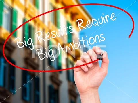 Man Hand writing Big Results Require Big Ambitions with black ma Stock Photos