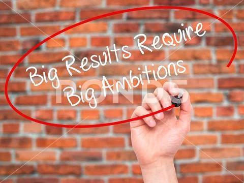 Man Hand writing Big Results Require Big Ambitions with black ma Stock Photos