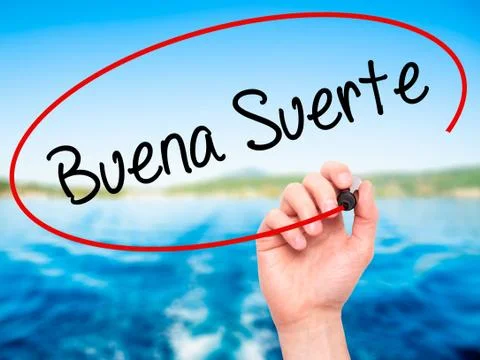 Man Hand writing Buena Suerte( Good Luck in Spanish) with black marker on vis Stock Photos