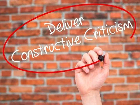 Man Hand writing Deliver Constructive Criticism with black marker on visual s Stock Photos