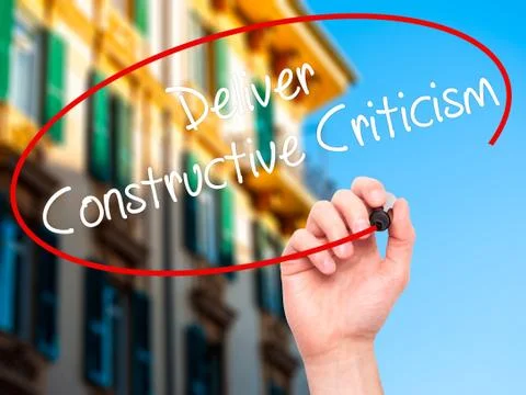 Man Hand writing Deliver Constructive Criticism with black marker on visual s Stock Photos