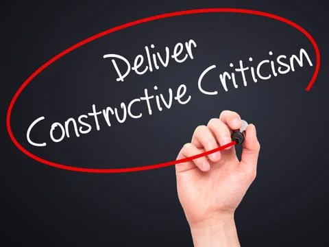 Man Hand writing Deliver Constructive Criticism with black marker on visual s Stock Photos