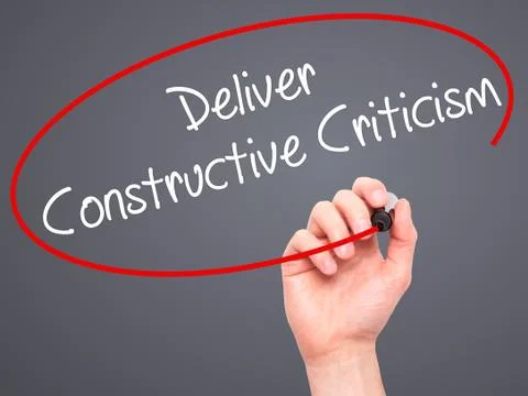 Man Hand writing Deliver Constructive Criticism with black marker on visual s Stock Photos