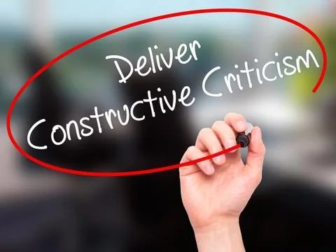 Man Hand writing Deliver Constructive Criticism with black marker on visual s Stock Photos