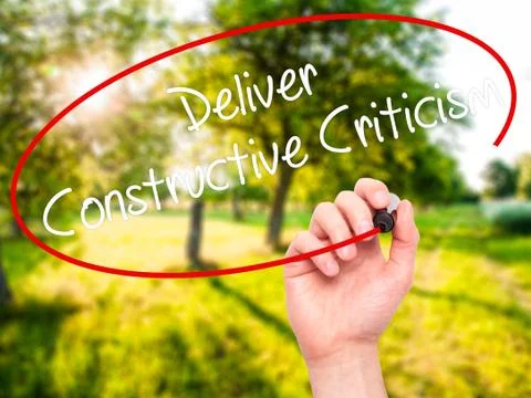 Man Hand writing Deliver Constructive Criticism with black marker on visual s Foto stock