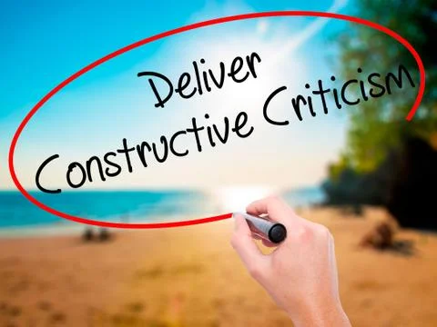 Man Hand writing Deliver Constructive Criticism with black marke Stock Photos