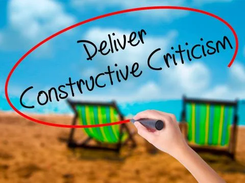 Man Hand writing Deliver Constructive Criticism with black marke Stock Photos