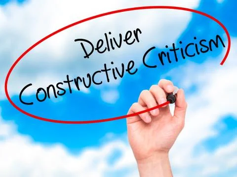 Man Hand writing Deliver Constructive Criticism with black marke Stock Photos