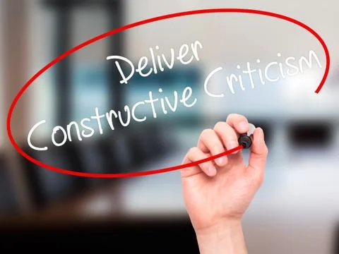 Man Hand writing Deliver Constructive Criticism with black marke Stock Photos