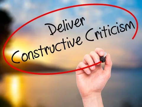 Man Hand writing Deliver Constructive Criticism with black marke Stock Photos