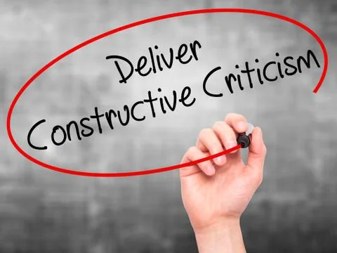 Man Hand writing Deliver Constructive Criticism with black marke Stock Photos