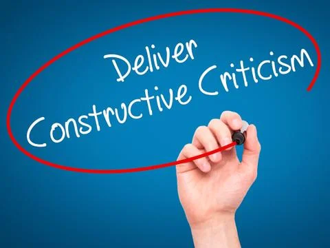 Man Hand writing Deliver Constructive Criticism with black marke Stock Photos