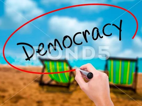 Man Hand writing Democracy with black marker on visual screen Stock Photos