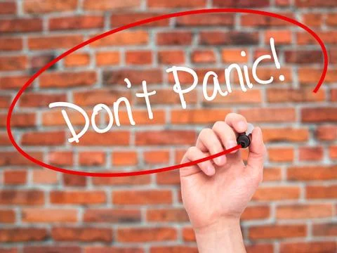 Man Hand writing Don't Panic! with black marker on visual screen Stock Photos
