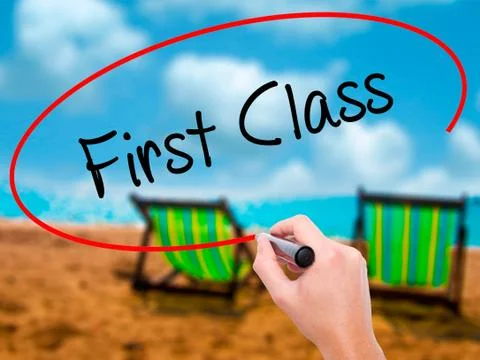 Man Hand writing First Class with black marker on visual screen Stock Photos
