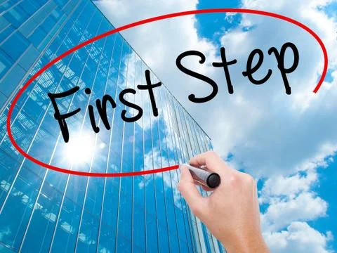 Man Hand writing First Step  with black marker on visual screen Stock-Fotos