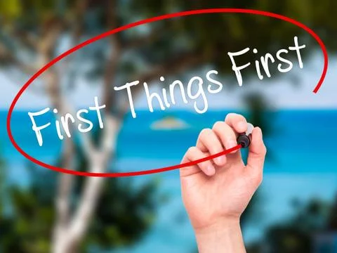 Man Hand writing First Things First with black marker on visual screen Stock Illustration