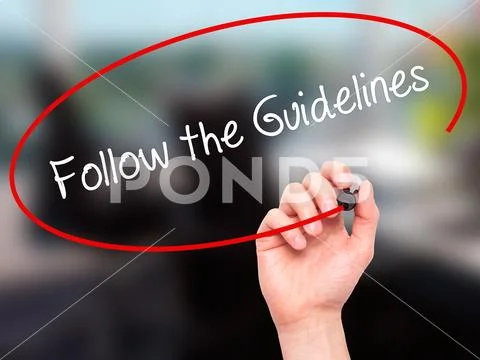 Man Hand writing Follow the Guidelines with black marker on vis Stock Photos