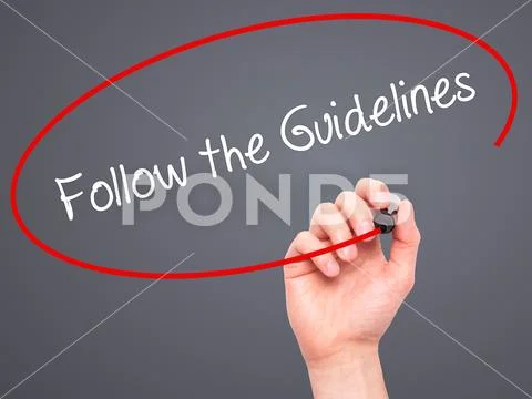 Man Hand writing Follow the Guidelines with black marker on vis Stock Photos