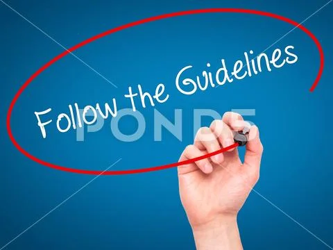 Man Hand writing Follow the Guidelines with black marker on vis Stock Photos