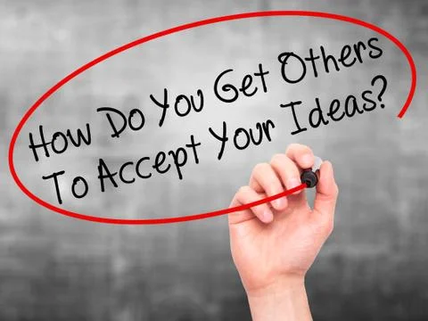 Man Hand writing How Do You Get Others To Accept Your Ideas? with black marke Stock Photos