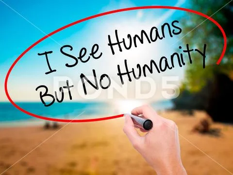 Man Hand writing I See Humans But No Humanity with black marker Stock Photos