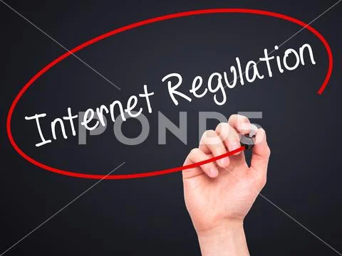 Man Hand writing Internet Regulation with black marker on visual Stock Photos
