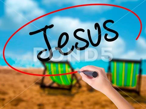Man Hand writing Jesus with black marker on visual screen Stock Photos