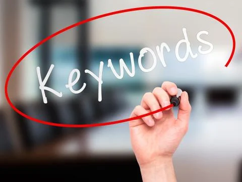 Man hand writing Keywords on visual screen Stock Photos