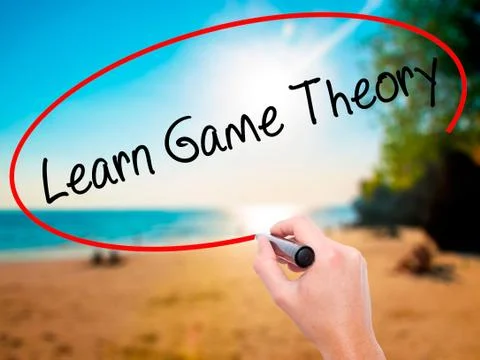 Man Hand writing Learn Game Theory with black marker on visual s 写真素材