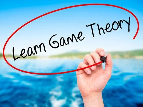 Man Hand writing Learn Game Theory with black marker on visual screen Man ... Stock Photos