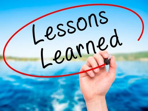 Man Hand writing Lessons Learned with black marker on visual scr Stock Photos