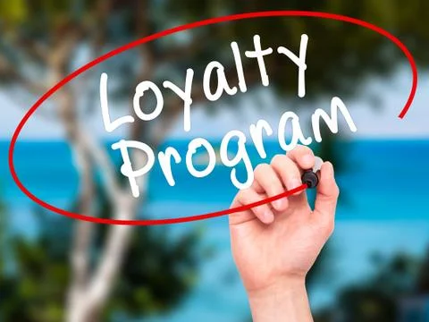 Man Hand writing Loyalty Program with black marker on visual screen Stock Photos