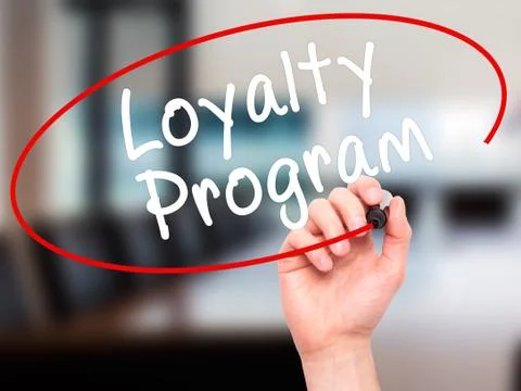 Man Hand writing Loyalty Program with black marker on visual screen Stock Photos