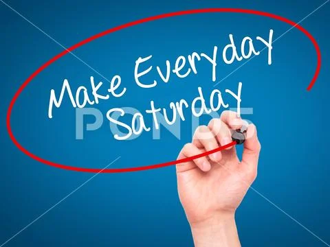 Man Hand writing Make Everyday Saturday with black marker on visual screen. Stock Photos