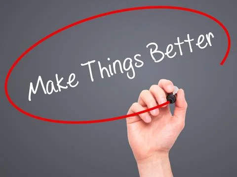 Man Hand writing   Make Things Better with black marker on visual screen Stock Photos