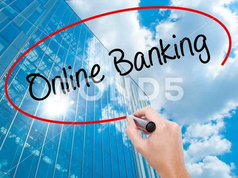 Man Hand writing Online Banking with black marker on visual scre Stock Photos