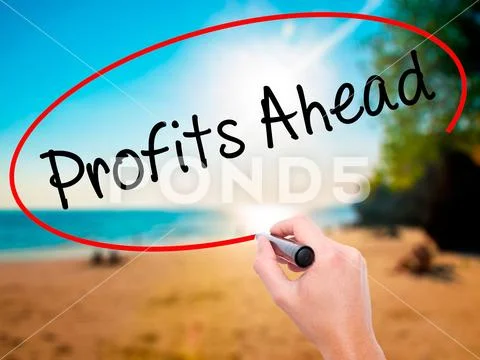 Man Hand writing Profits Ahead with black marker on visual scr Stock Photos