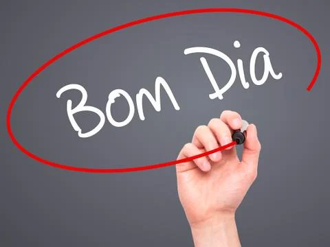 Man Hand writing &quot;Bom Dia&quot; (In portuguese - Good Morning)  with bla Stock Photos