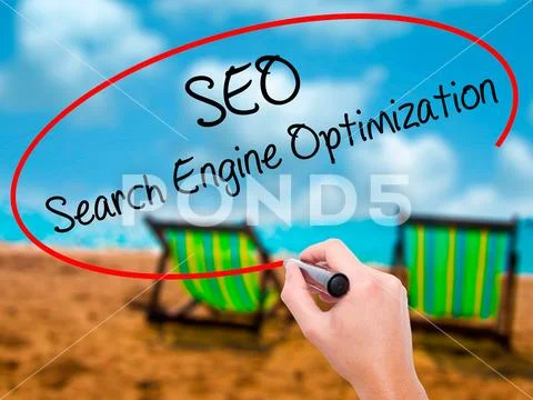 Man Hand writing SEO Search Engine Optimization with black marke Stock Photos
