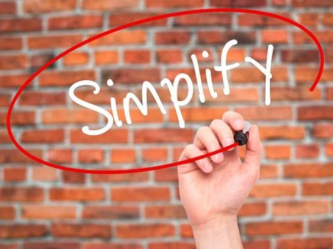 Man Hand writing Simplify with black marker on visual screen Stock Photos
