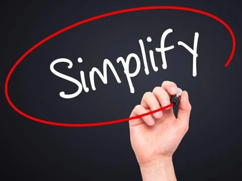 Man Hand writing Simplify with black marker on visual screen Stock Photos